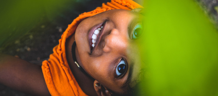 Child in India smiling and looking up