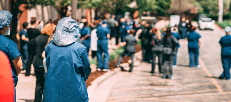 Doctors in blue uniform walking down the streets